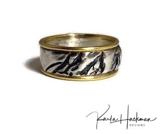 Hand carved in wax and cast in sterling silver, this hand-fabricated ring is edged in solid 18 karat gold on both sides. Ring is given an oxidized finish to highlight the abstract, natural organic texture.