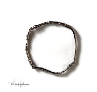 Apple branches from Karla's garden in Santa Fe are picked and cast in sterling silver and then fabricated into individual bangles. Bangles are given an oxidized finish to highlight their beautiful, natural texture.