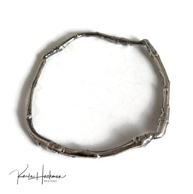 Apple branches from Karla's garden in Santa Fe are picked and cast in sterling silver and then fabricated into individual bangles. Bangles are given an oxidized finish to highlight their beautiful, natural texture.