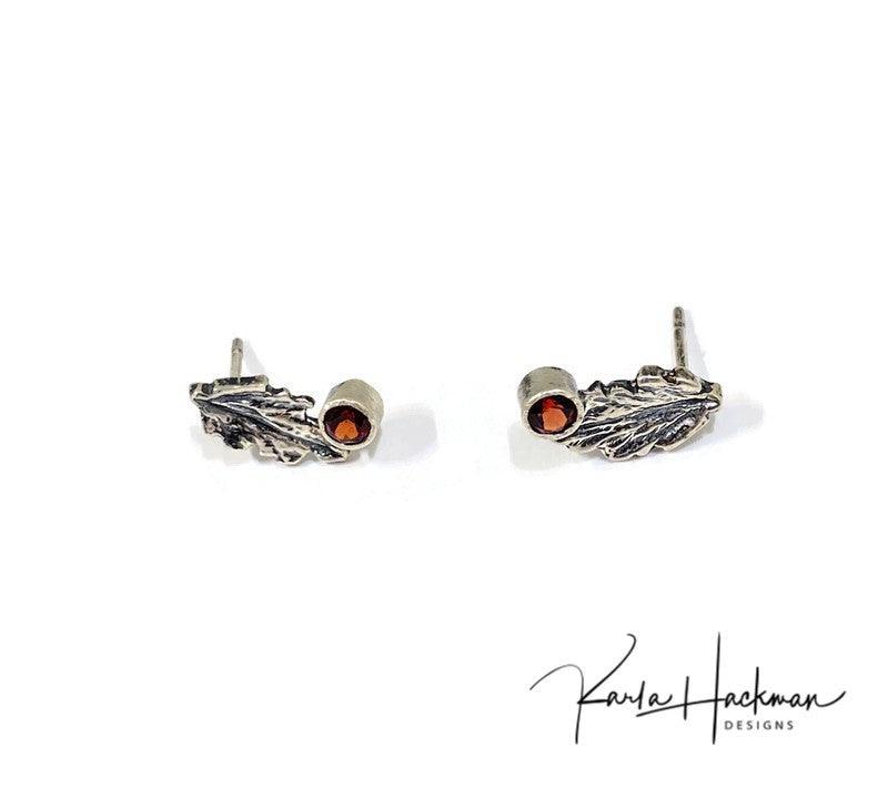 Leaf Studs in Sterling Silver with Gemstones - Karla Hackman DesignsSterling Silver Leaf Studs are Karla's inspired take on her childhood spent playing in the woods. Each piece features a hand-carved oak leaf, with a 3mm peridot gemstone