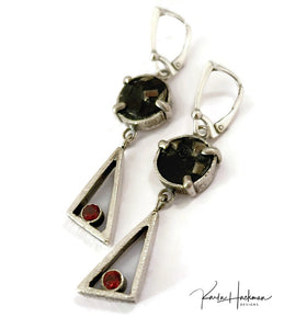 a classic triangle drop shape featuring a sparkly 5mm garnet gemstone and  pyrite shimmering in a round slate background above, these sterling silver handmade gemstone earrings are rock-star style.