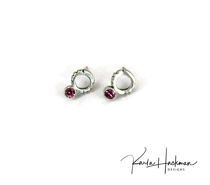  Petite circle studs, featuring a line texture and a 3mm rhodolite garnet, are sterling silver studs. These will make a bold statement without taking over your look.