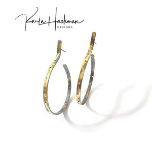 Sterling silver and detailed with 24K gold, these industrial hoop earrings are sure to stand out with their unique texture and pierced holes