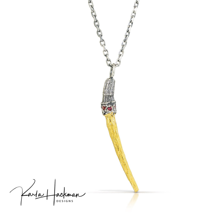 a single tulip poplar stem cast in sterling silver, and gilded in 24K gold using the ancient Keum Boo technique, this stunningly oxidized piece will turn heads for sure! Pendant is finished with five 1.5mm red sapphires bead set in the silver just above the gold. 