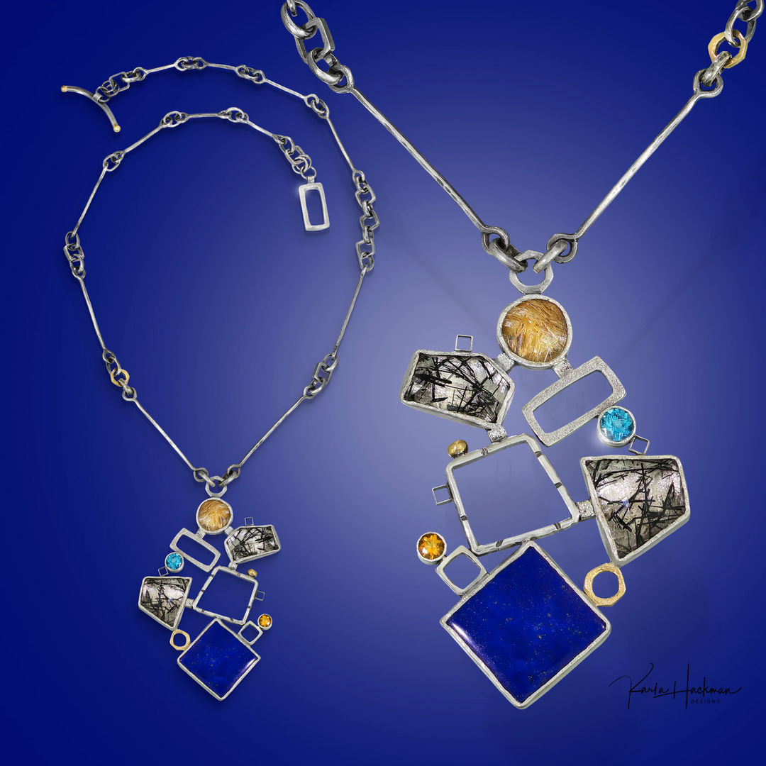 Silver necklace with geometric pendants and gemstones on a blue background