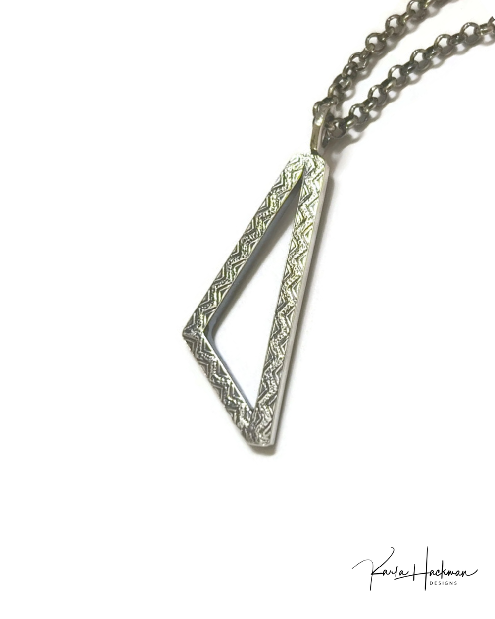Silver necklace with a geometric pendant on a white background