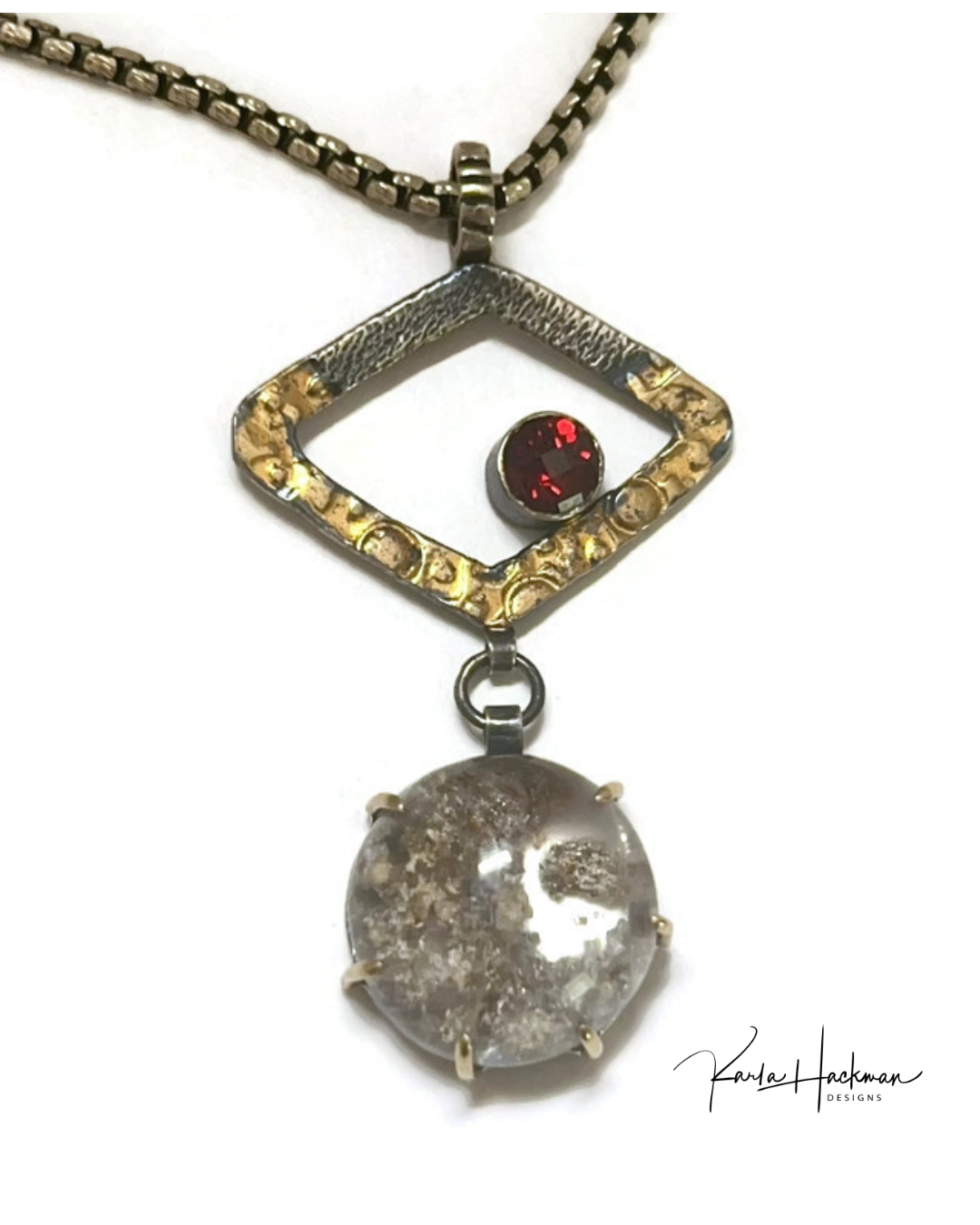 Necklace with a pendant featuring a red gemstone and textured stone on a white background