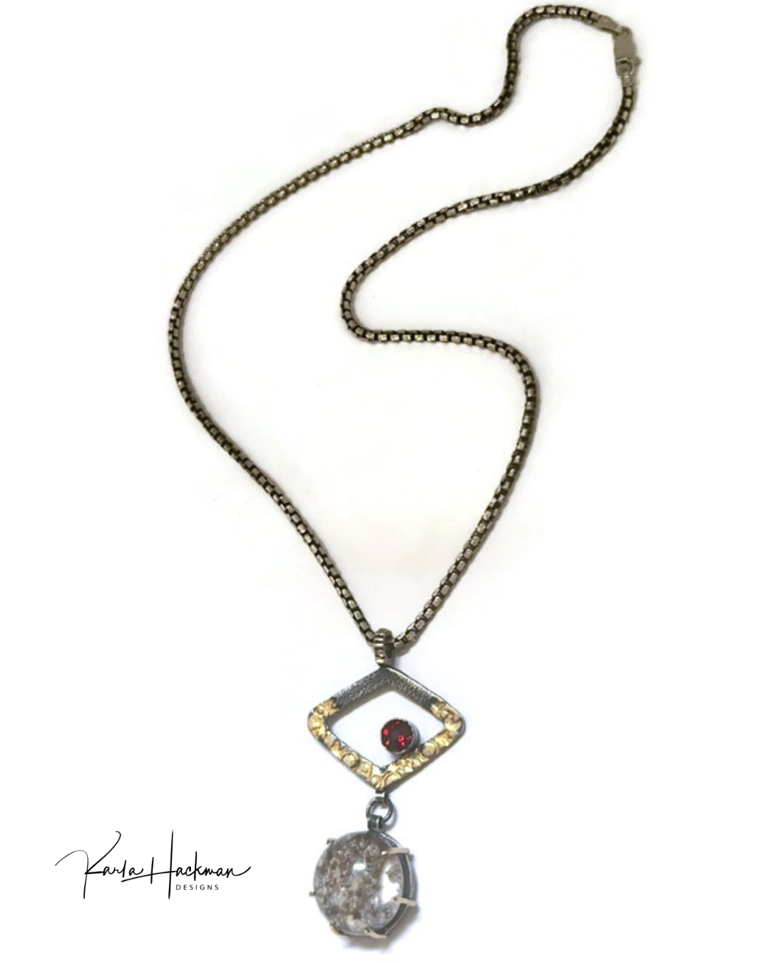 Necklace with a pendant featuring a red gemstone and clear crystal with internal texture on a white background.