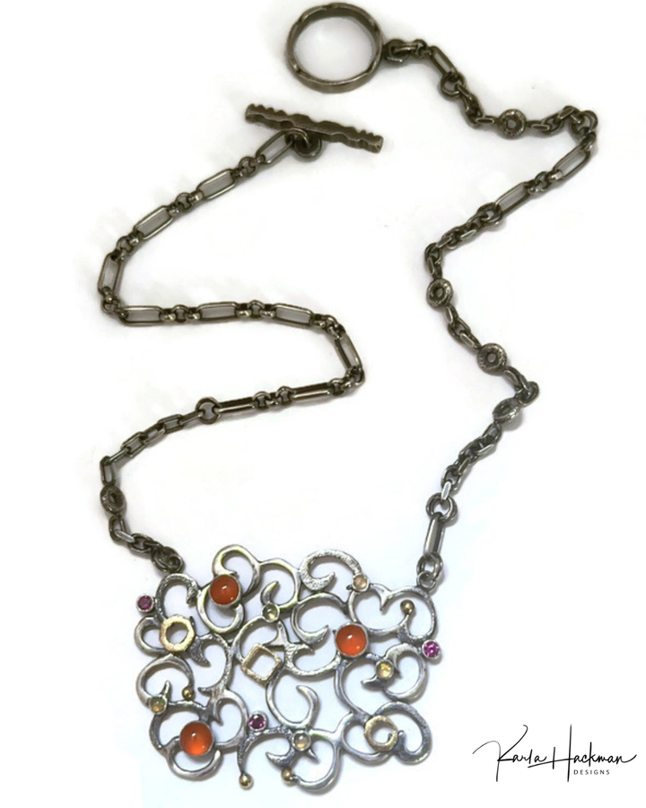Ornate necklace with multicolored stones on a white background