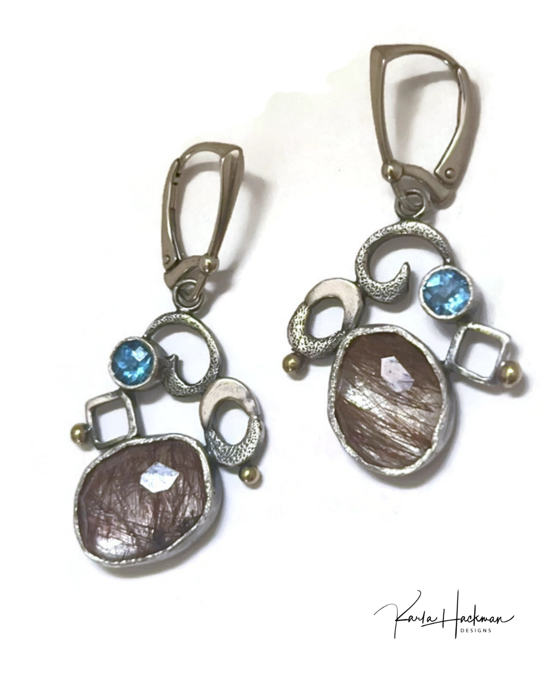 Pair of earrings with brown and blue gemstones on a white background