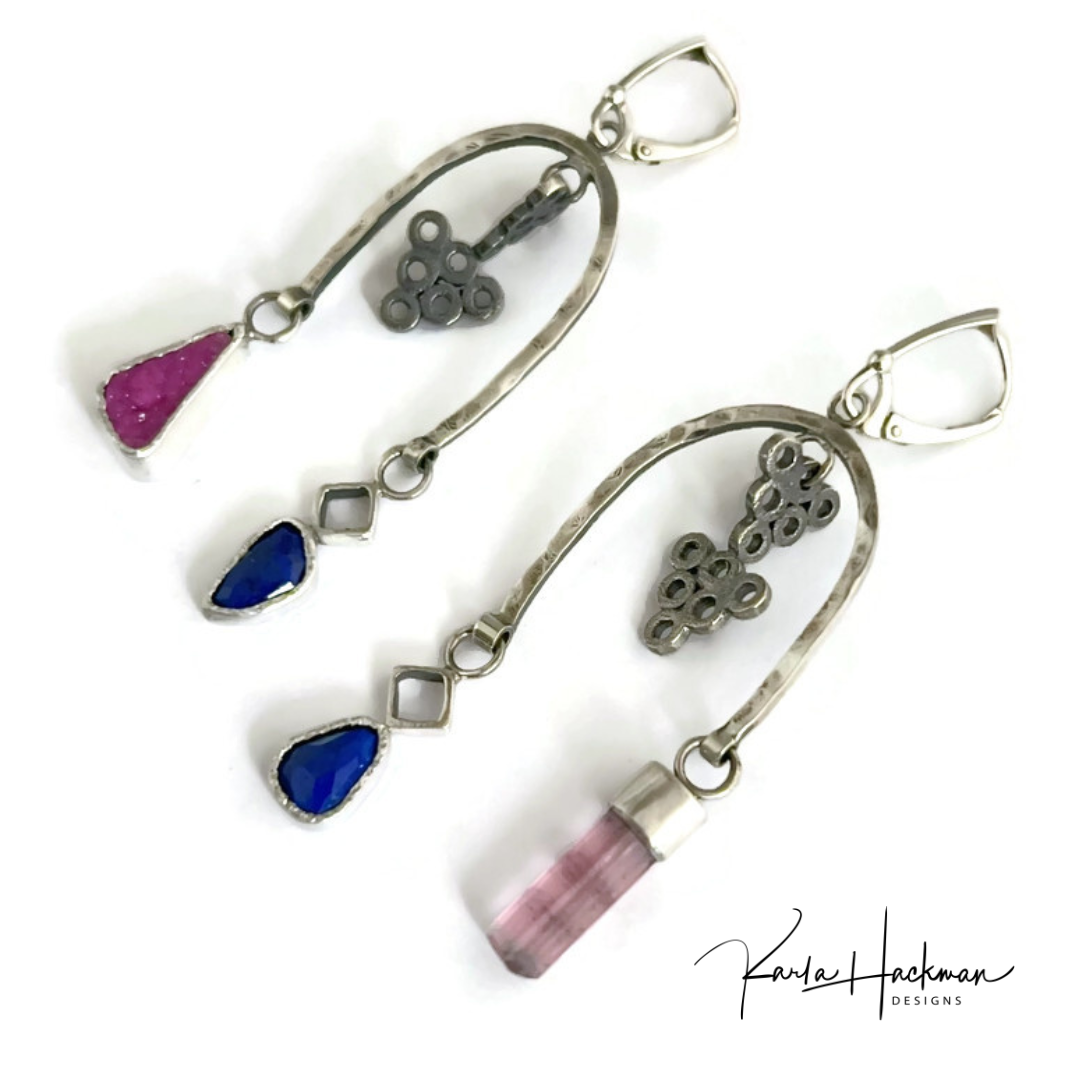 Silver earrings with colorful gemstones on a white background,.
