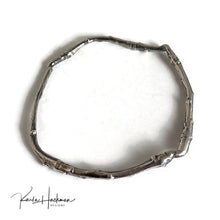 Load image into Gallery viewer, Apple branches from Karla&#39;s garden in Santa Fe are picked and cast in sterling silver and then fabricated into individual bangles. Bangles are given an oxidized finish to highlight their beautiful, natural texture.
