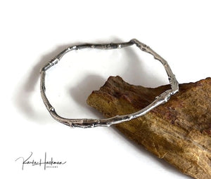 Apple branches from Karla's garden in Santa Fe are picked and cast in sterling silver and then fabricated into individual bangles. Bangles are given an oxidized finish to highlight their beautiful, natural texture.