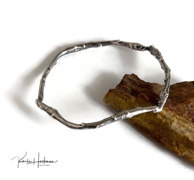 Apple branches from Karla's garden in Santa Fe are picked and cast in sterling silver and then fabricated into individual bangles. Bangles are given an oxidized finish to highlight their beautiful, natural texture.