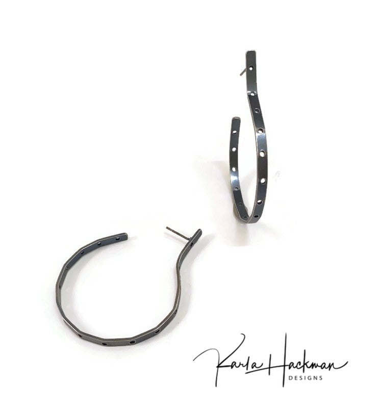 Hand-fabricated sterling silver hoops, with a post, are given a modern shape and pierced with over a dozen holes to create a contemporary, chic earring.