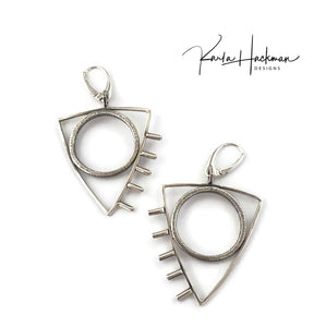 These earrings are a little rock and roll and a whole lot of fun! Large sterling silver, textured circles are surrounded by triangles and finished with tube accents. Earrings are lightly oxidized and finished with lever backs. Solid sterling silver.